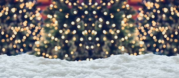 Empty white snow with blur Christmas tree with bokeh light background - Photo, Image