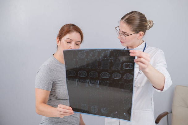 Ženský lékař vysvětlující mri vnitřních orgánů pacientce - Fotografie, Obrázek