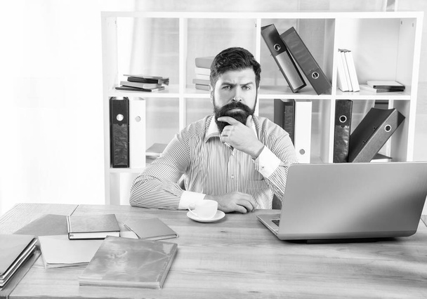 Serious man at workplace. Thinking man sitting at office desk. - Fotó, kép