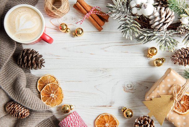 Christmas and winter cozy background with warm sweater, cookies, coffee and decorations. - Photo, Image