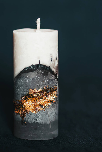 An incredibly beautiful candle on a clean background. Handmade wax and concrete candle with gilding. Holiday advent. Cozy atmosphere - Foto, immagini