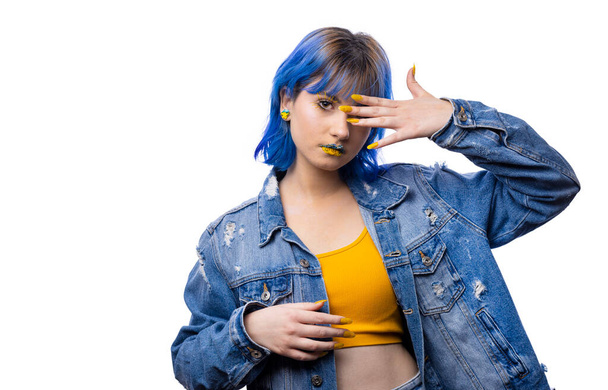 Portrait of young stylish woman posing, blue and yellow tones of clothes, ukrainian colors style - 写真・画像