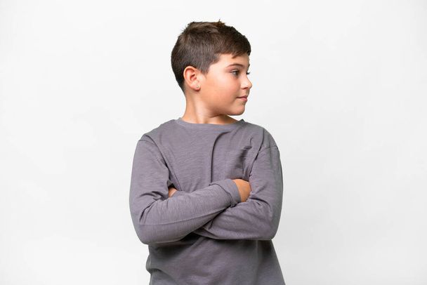 Little caucasian kid over isolated white background keeping the arms crossed - Foto, Imagem