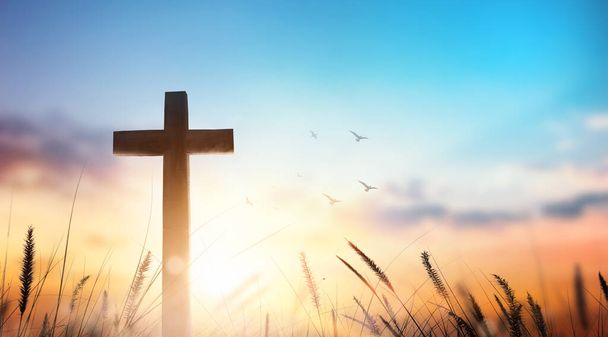Christian wooden cross on sunset background. - Photo, Image