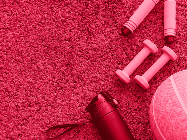 accessories for fitness on the magenta background. Viva magenta color of the 2023 year - Fotografie, Obrázek