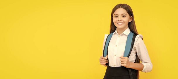 happy kid in school uniform carry backpack, copy space, back to school. Banner of schoolgirl student. School child pupil portrait with copy space - Valokuva, kuva