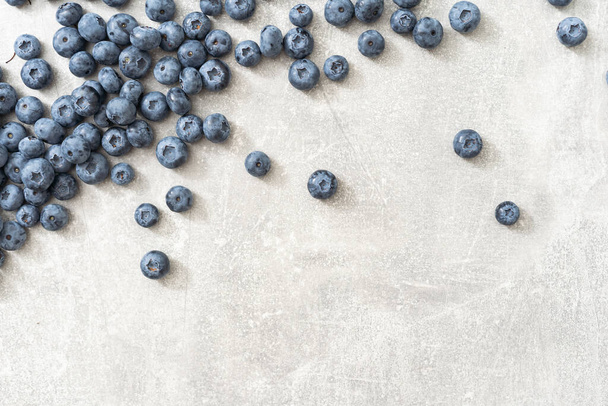 Top view of a group of fresh blueberries on gray background - Photo, Image