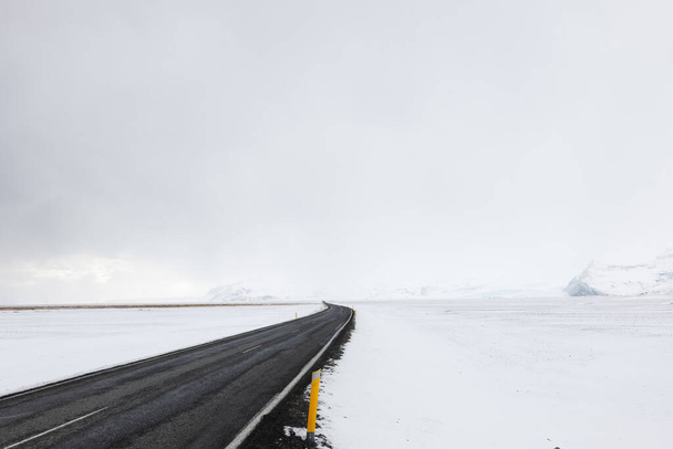 Út vezet keresztül a fagyasztott havas táj Dél-Izland télen - Fotó, kép