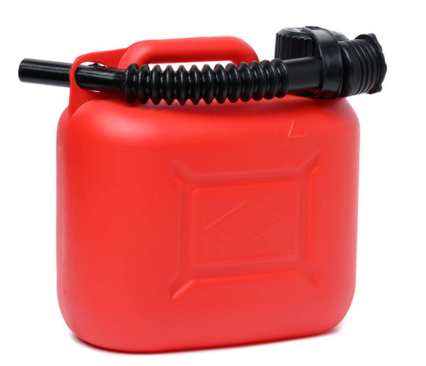 Red plastic canister for liquid fuels and lubricants on a white isolated background, and black watering can - Photo, Image