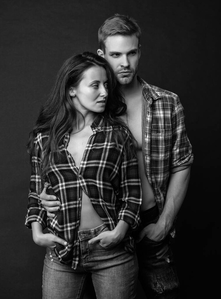 fashion and beauty. sexy couple in love on black background. young people. man and woman. guy and girl standing together. togetherness. concept of romantic relationship. - 写真・画像
