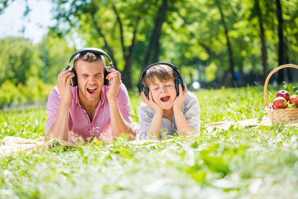 Father and son enjoying music - Фото, изображение