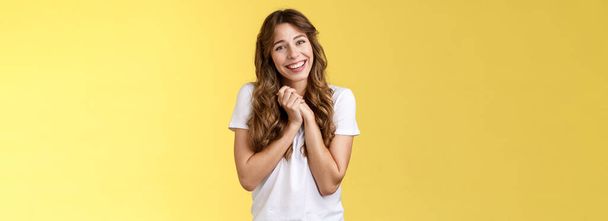 Tender lovely cute curly-haired girlfriend sighing happily clasp hands togehter appreciate touching perfect gift tilt head smiling broadly grateful thanking effort stand pleased yellow background - Photo, Image