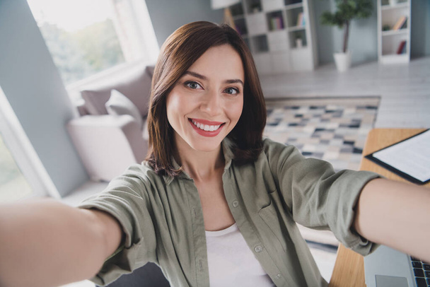 Photo of charming cheerful lady make selfie recording video toothy smile spacious modern office inside. - Valokuva, kuva