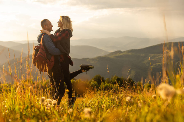 travel to mountains, tourists hikers with backpacks at sunset enjoying panoramic view. - 写真・画像