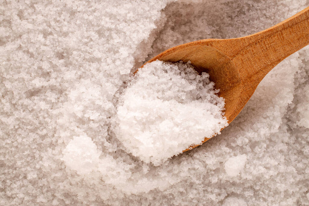 Rock salt with wooden spoon, macro, top view. - Photo, Image