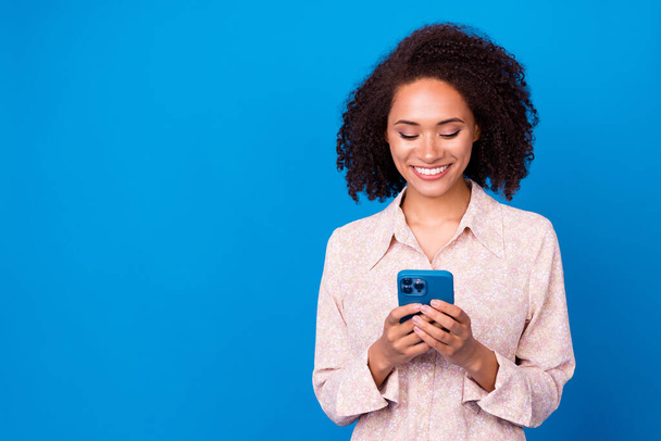 Portrait of nice cheerful person hands hold telephone chatting typing isolated on blue color background. - Foto, Imagem