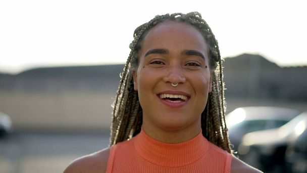 Portrait of a black hispanic latin young woman smiling at camera. Brazilian latin adult girl closeup face - Φωτογραφία, εικόνα