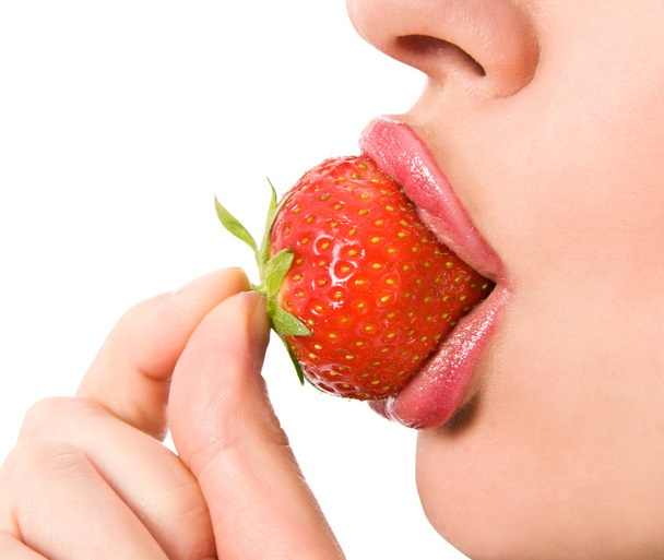 Closeup of a young girl mouth with a strawberry - Fotoğraf, Görsel