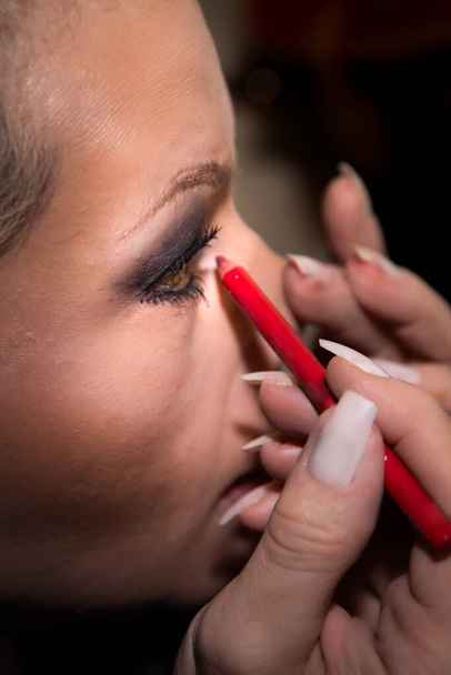 Beautiful blonde woman applying makeup close up - Photo, Image