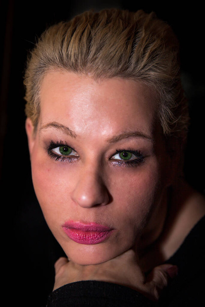 Portrait of a beautiful blonde woman with green eyes face on - Photo, Image
