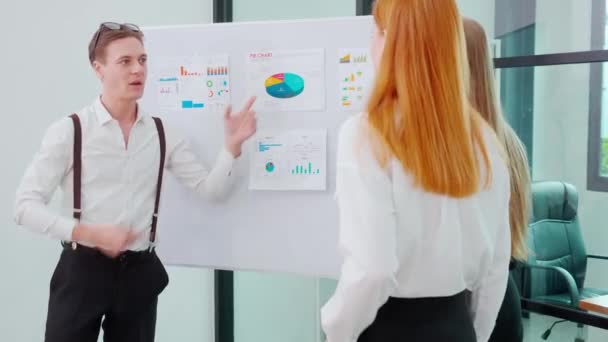 Group team business people meeting marketing about finance and profit while businessman presentation and explaining chart and graph on whiteboard with colleagues for planning and brainstorm. - Footage, Video