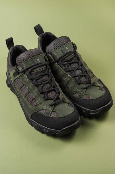 Military sneakers on a green background. Khaki army shoes - Foto, immagini