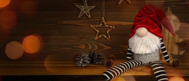 Christmas gnome with decorations on wooden background with space for text - Photo, Image