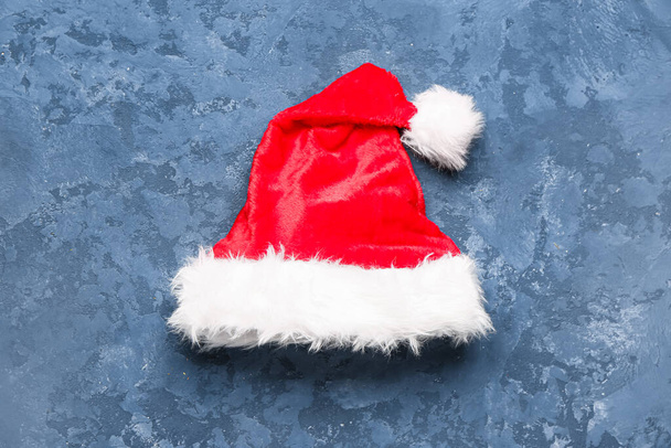 Red Santa hat on blue background - Photo, Image