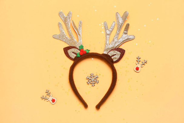 Funny Christmas reindeer horns, decor and sequins on color background - Photo, Image