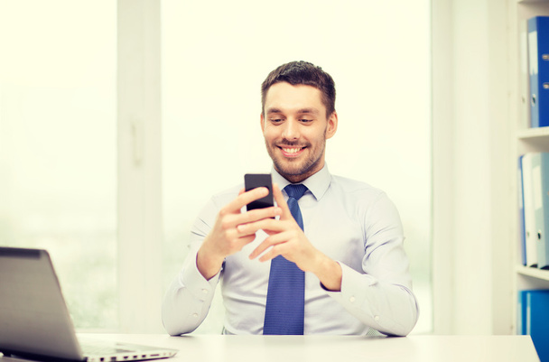 businessman with laptop and smartphone at office - Photo, image