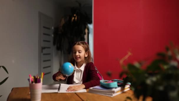 Happy uczennica w miejscu pracy studiuje globus w klasie, Powrót do szkoły, koncepcja edukacji. - Materiał filmowy, wideo