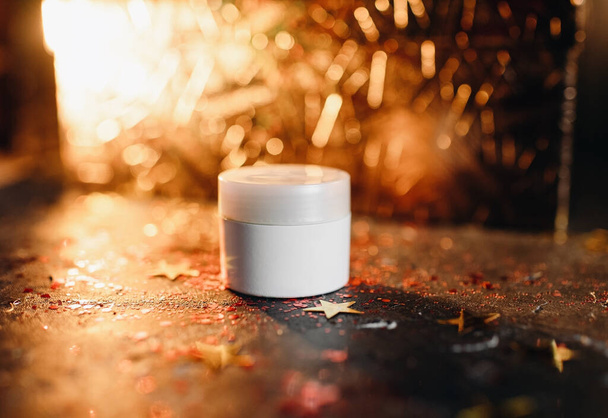 mockup of a tube of cream on a festive shining background, night cream for skin - Foto, Imagem