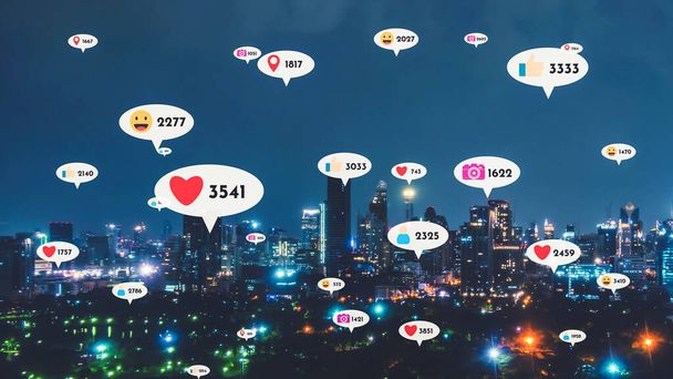 Social media icons fly over city downtown showing people reciprocity connection through social network application platform . Concept for online community and social media marketing strategy . - Photo, Image