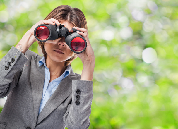 Executive young woman with binoculars - Photo, Image