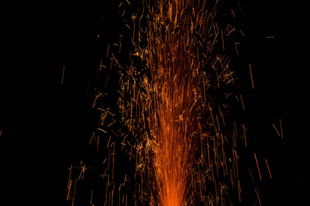 close up burning flare or flame with bright sparks and smoke on background with copy space. festive event concept. fireworks exploding at night - Photo, Image