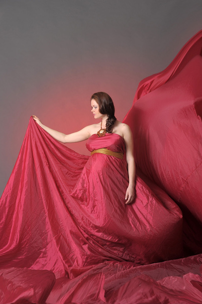Pregnant woman in red flying dress - Φωτογραφία, εικόνα