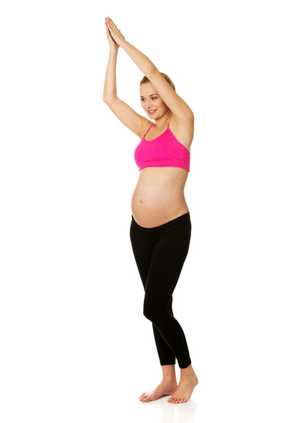 Pregnant woman exercising  yoga - Фото, изображение