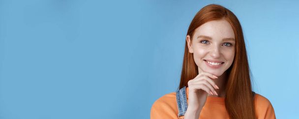 Curieux intelligent créatif jeune rousse féminine yeux bleus ont une idée parfaite comment passer des vacances d'été souriant regard joyeux intrigué toucher réfléchi menton réfléchissant choix, debout fond bleu. - Photo, image