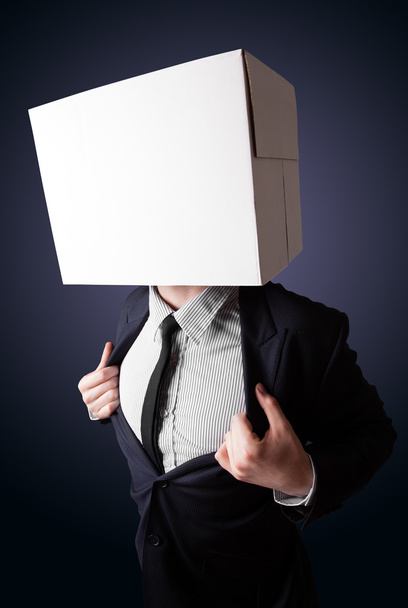 Businessman gesturing with a cardboard box on his head - 写真・画像