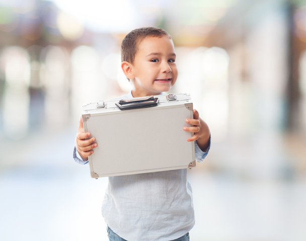 Little boy holding heavy briefcase - Фото, зображення