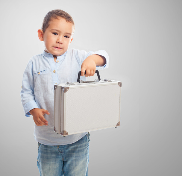 Little boy holding briefcase - Fotó, kép