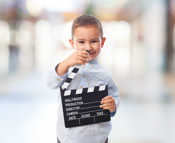 Little boy holding clapper board - Foto, imagen