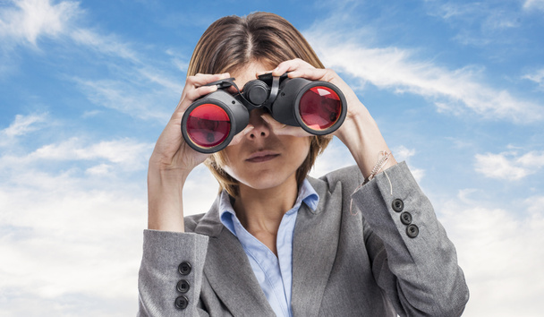 Young woman looking through binoculars - Photo, Image
