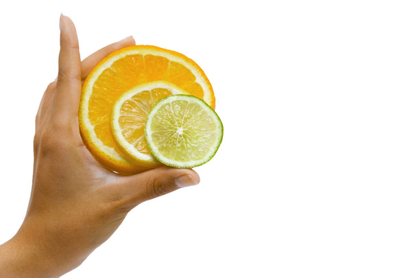 Orange, lemon and lime in the hand on the white - Φωτογραφία, εικόνα