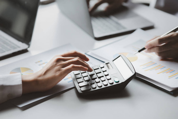 A female financier is reviewing company financial documents, monthly financial statement summary from the finance department. The concept of managing the company's finances for accuracy and growth. - Foto, Imagem