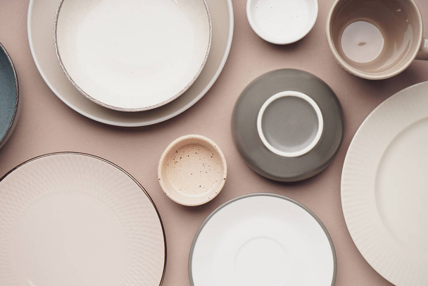 Different clean dishware on beige background - Photo, Image
