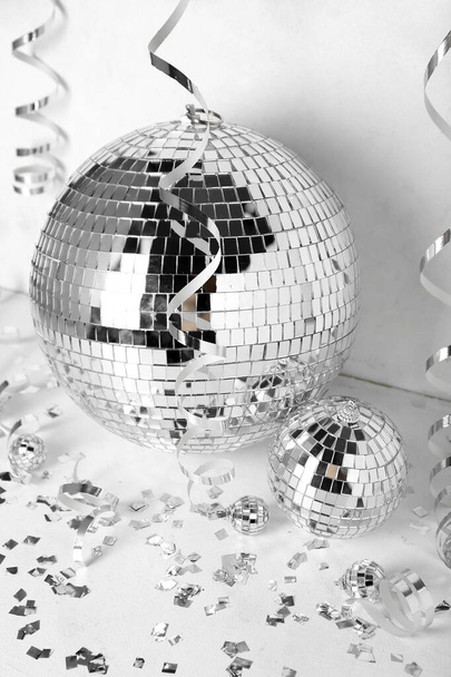 Disco balls with serpentine and confetti on white background - Photo, Image