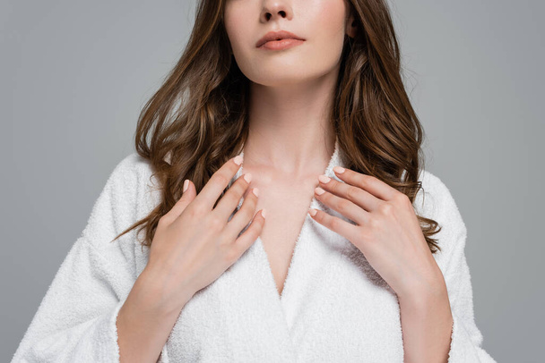 cropped view of young woman in bathrobe touching shiny and healthy hair isolated on grey - Φωτογραφία, εικόνα