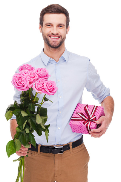 Man holding gift box and bouquet - Valokuva, kuva