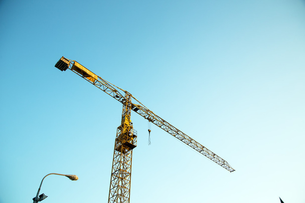 Industrial crane against blue sky - Foto, Bild